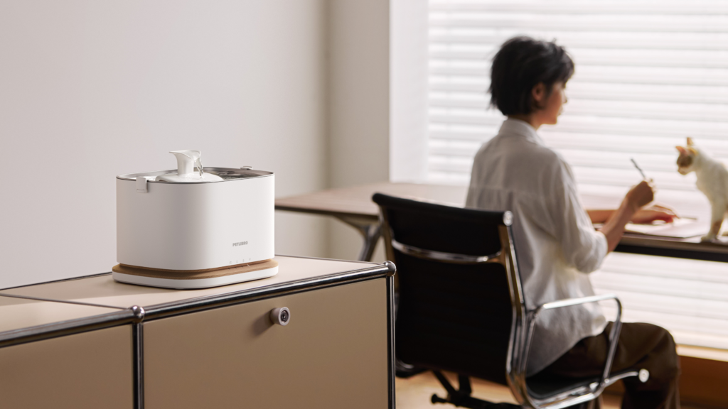 PETLIBRO Dockstream 2 smart cat water fountain in a modern home office while a cat drinks nearby